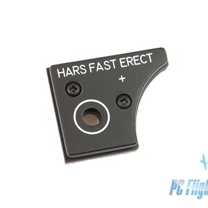 May include: Black plastic panel with the text "HARS FAST ERECT" and a plus sign. There are two screw holes and a circular cutout.
