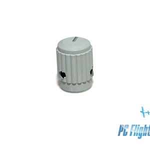 May include: A grey plastic knob with a ribbed design and a small hole on each side.