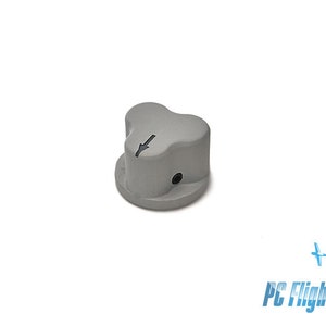 May include: A gray plastic knob with a three-pronged design and a downward arrow printed on the top.