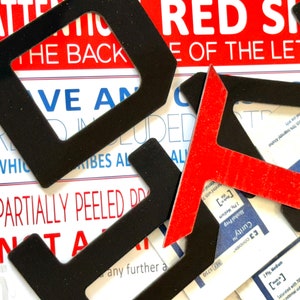 May include: Black and red letter stencils with the text "ATTENTION RED SEAL" and "THE BACK SIDE OF THE LETTER" on a white background.