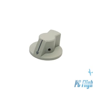 Puede incluir: Una perilla de plástico gris con una flecha hacia abajo impresa en ella. La perilla tiene una base redonda y una parte superior elevada y angulada.