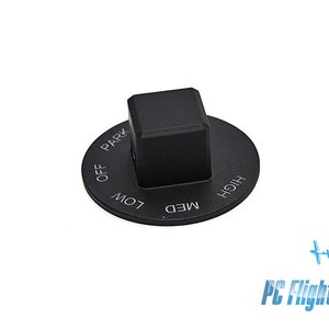 Op de afbeelding: Zwarte knop-schakelaar met een vierkante knop en een ronde basis. De basis heeft de woorden "OFF", "LOW", "MED", "HIGH" en "PARK" eromheen gedrukt.