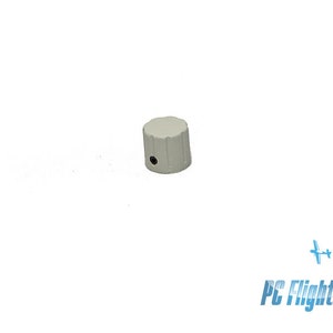 May include: A white plastic knob with a small hole in the centre. The knob has a ribbed design.