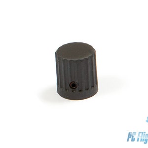 May include: A black, cylindrical control knob with a ridged surface. The knob has a small hole on its side and is set against a white background. The product is likely a component for electronics or machinery.