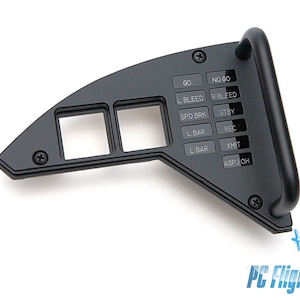 Puede incluir: Panel de plástico negro con una serie de interruptores de palanca etiquetados "GO", "NO GO", "L BLEED", "R BLEED", "SPD BRK", "STBY", "L BAR", "REC", "L BAR", "XMIT" y "ASP JOH".