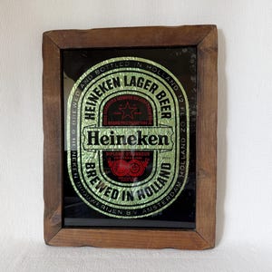 Vintage Heineken beer mirror sign in wooden frame with classic logo and bar decor style