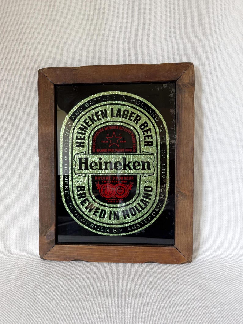 Vintage Heineken beer mirror sign in wooden frame with classic logo and bar decor style