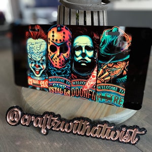 May include: Four horror movie character faces on a black background. The characters are Freddy Krueger, Jason Voorhees, Michael Myers, and Pennywise. The text "Welcome to Camp Crystal Lake", "Welcome to Elm Street", and "Welcome to Haddonfield" is visible on the image.