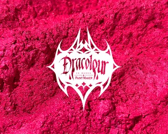 May include: Close-up of a pile of bright pink glitter pigment. The glitter is very fine and has a slight shimmer. The text "Dracolour UK Based Paint Maker" is visible in the center of the image.