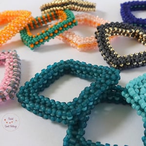 Small stacking rings in an unusual square shape. Hand-threaded from small glass beads. Customizable in many color combinations