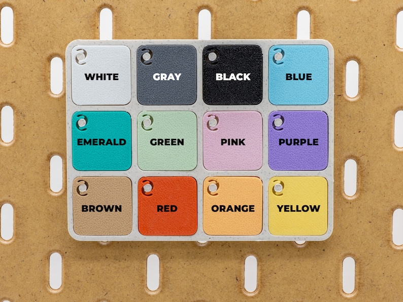 May include: A color palette with twelve square color swatches labeled with the colors white, gray, black, blue, emerald, green, pink, purple, brown, red, orange, and yellow. The color swatches are arranged in a grid.