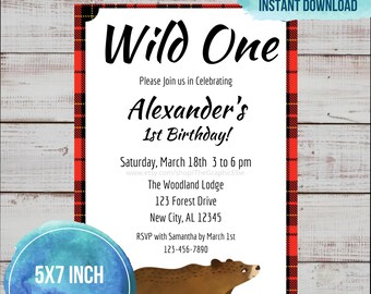May include: A 5x7 inch invitation for a first birthday party with a red and black plaid background. The invitation says "Wild One" and features a cartoon brown bear. The text on the invitation says "Please join us in celebrating Alexander's 1st Birthday!" and includes the date, time, location, and RSVP information.