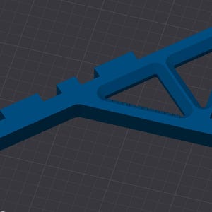 May include: A blue plastic 3D printed object with a triangular shape and a flat base. The object has a series of small rectangular protrusions along one side.