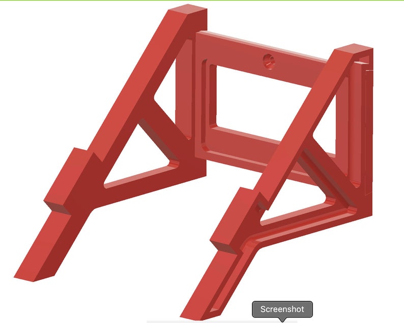 May include: Red plastic wall mount stand with a rectangular opening in the center. The stand is designed to hold a device or object.