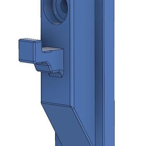May include: A blue plastic door stop with a hook on the side. The door stop has a round hole in the top.