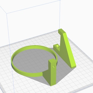 May include: A 3D printed green plastic holder for a circular object, such as a cup or a plate. The holder has a base and a ring that can be adjusted to fit different sizes.
