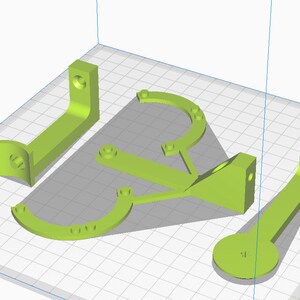 May include: Five lime green 3D printed parts for a project. The parts are a curved bracket, a straight bracket, a small round piece, and two larger curved brackets.