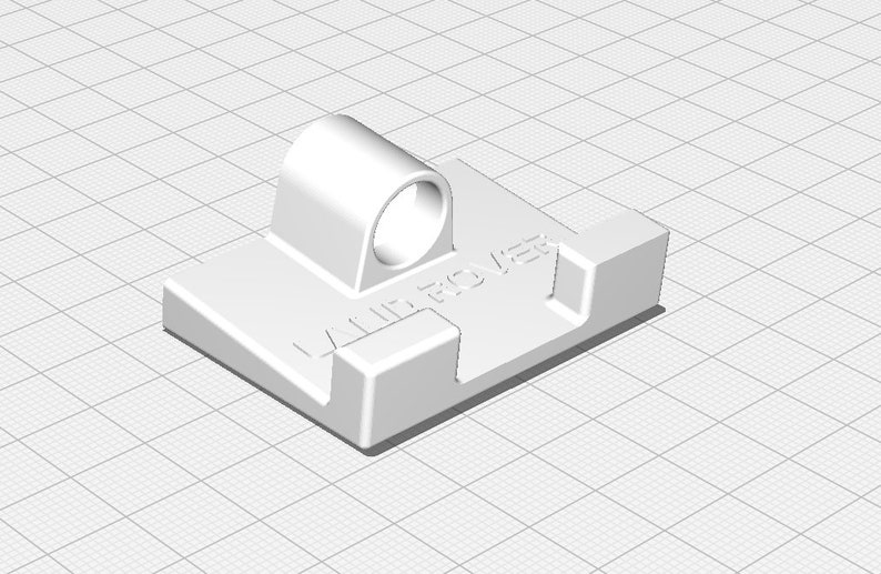 May include: White plastic phone holder with a Land Rover logo and a ring on top.