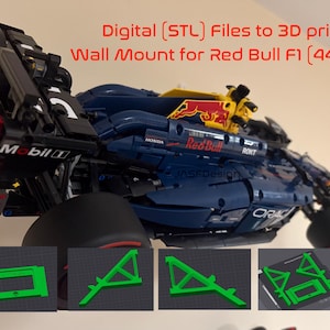 May include: A 3D-printed wall mount for a Red Bull F1 model. The model is primarily blue with red and yellow accents, and the text "Digital (STL) Files to 3D print Wall Mount for Red Bull F1 (44206)" is visible. Several green 3D-printed support structures are shown.