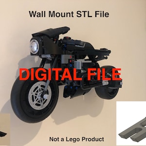 May include: A black motorcycle wall mount, designed to hold a Lego motorcycle. The mount is made of plastic and has a simple design. The image also shows a close-up of the mount, which is printed in gray. The text "Wall Mount STL File" and "DIGITAL FILE" is visible in the image. The text "Not a Lego Product" is also visible in the image.