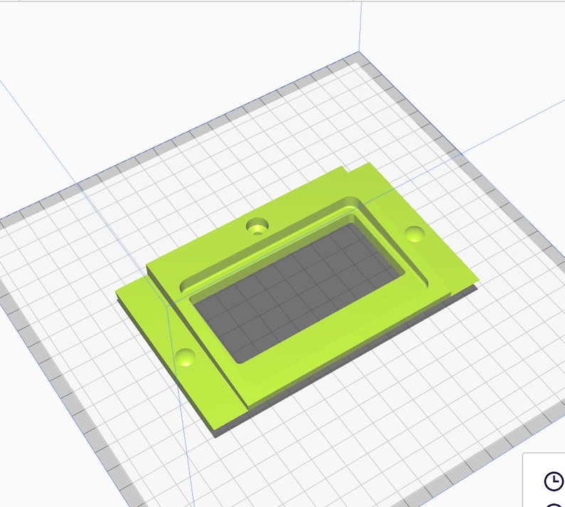 K&ouml;nnte beinhalten: Eine rechteckige Box aus limegr&uuml;nem Kunststoff, die im 3D-Druck hergestellt wurde und eine rechteckige Aussparung in der Mitte hat. Die Box hat vier L&ouml;cher an den Seiten.