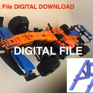 May include: A digital download of an STL file for a 3D printed model of a race car. The car is orange and black with blue accents. The STL file is for a stand to display the car. The stand is blue and has a rectangular base with two angled supports.