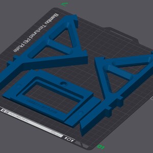 May include: Blue 3D-printed components arranged on a dark gray surface. The components include two triangular shapes and a rectangular frame. The text "Bambu Textured PET Plate" is visible. The components are likely for a 3D printer.