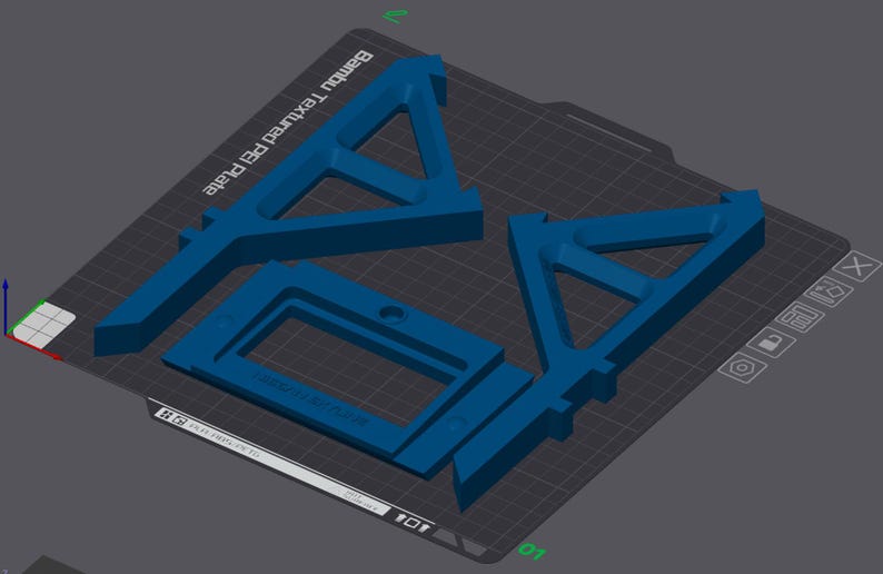 May include: Blue 3D-printed components arranged on a dark gray surface. The components include two triangular shapes and a rectangular frame. The text "Bambu Textured PET Plate" is visible. The components are likely for a 3D printer.