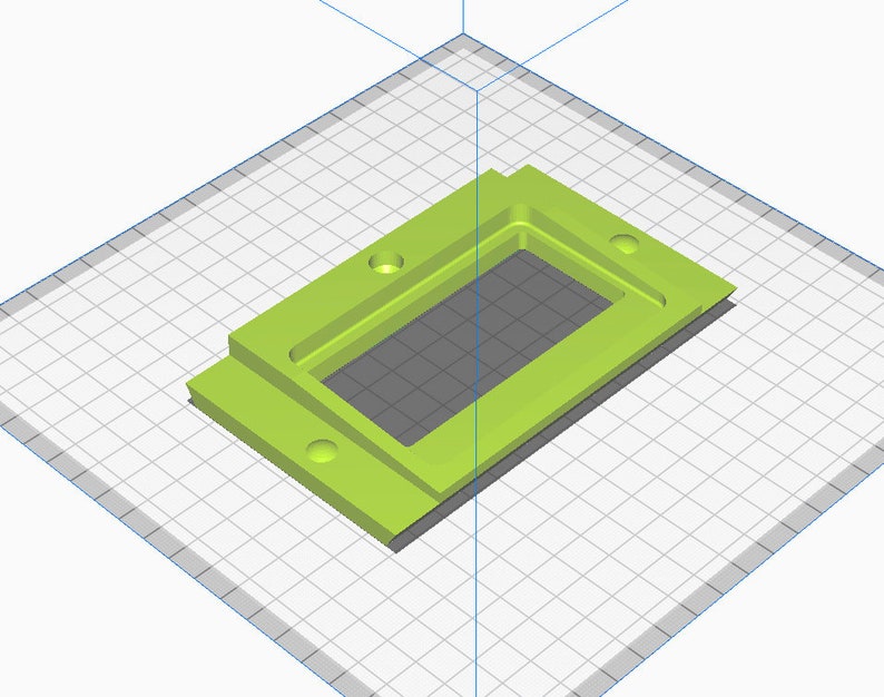 May include: A green plastic rectangular box with a cutout in the center. The box has four holes on the sides.