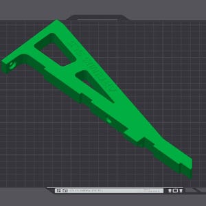 May include: A green plastic 3D printed part with the text "STEFAN" printed on it. The part is on a gray grid background.