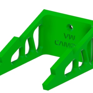 May include: Green plastic wall mount with cutouts and the text "VW CAMP" printed on the front.