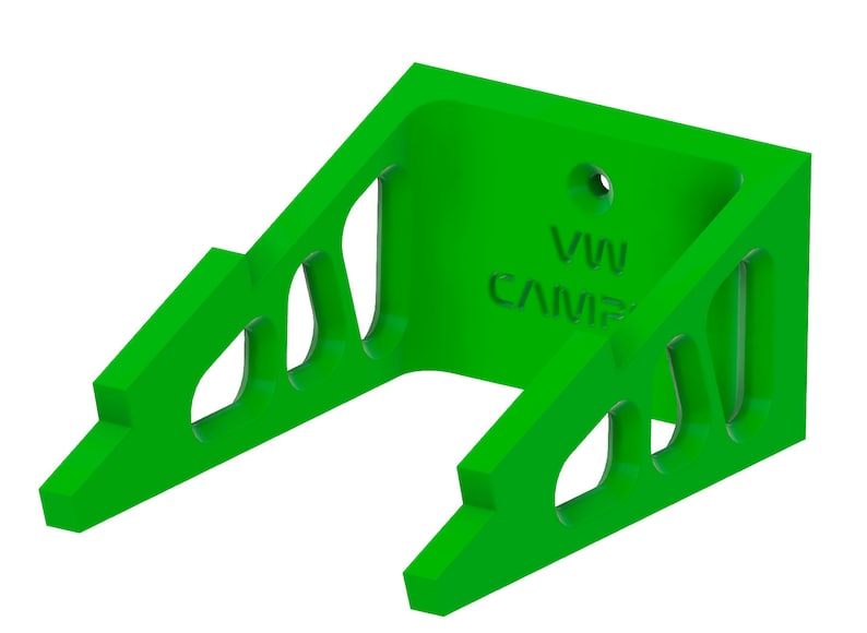 May include: Green plastic wall mount with cutouts and the text "VW CAMP" printed on the front.