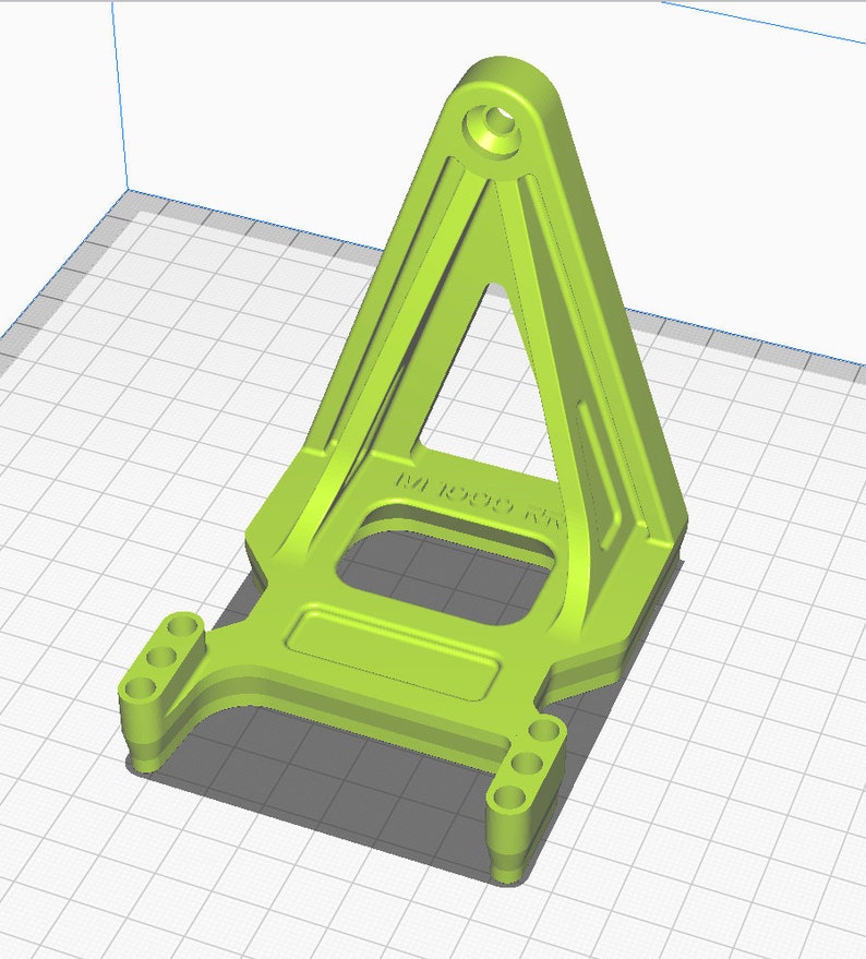 May include: A green plastic 3D printed part with a triangular base and a rectangular platform with four holes on each side. The part has the text "M1 R0000 K1" printed on it.