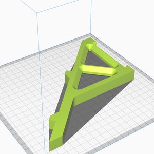 May include: A green plastic 3D printed model of a triangular stand with a hollow center. The stand is designed with a series of internal supports.