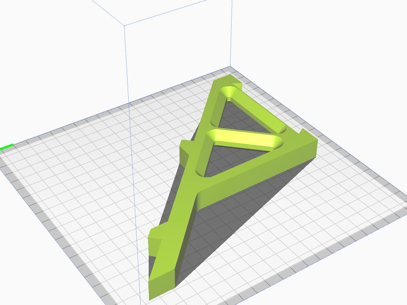 May include: A green plastic 3D printed model of a triangular stand with a hollow center. The stand is designed with a series of internal supports.
