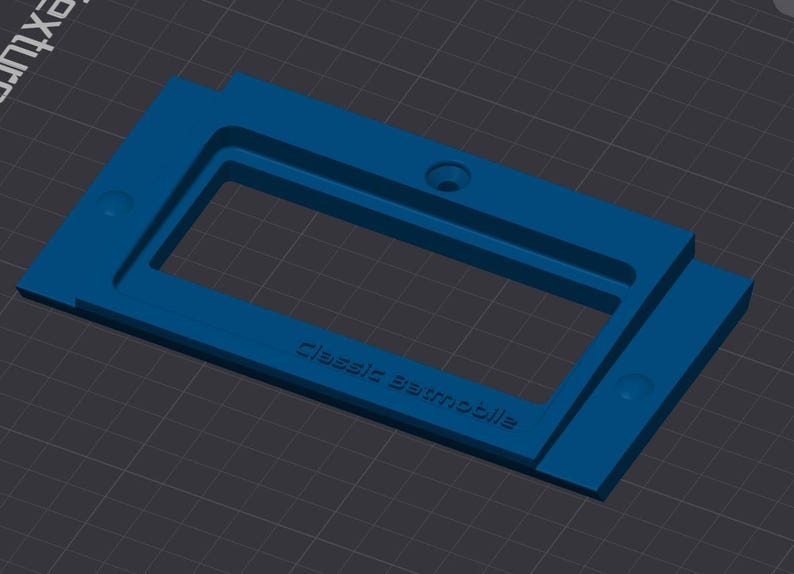 May include: A blue plastic mold for making a classic automobile model. The mold has a rectangular opening with the words "Classic Automobile" inscribed on the bottom.