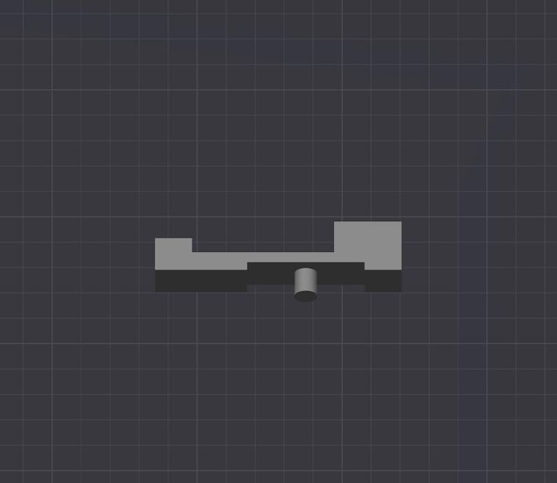 Puede incluir: Un juguete de balanc&iacute;n de pl&aacute;stico gris con una base redonda de pl&aacute;stico gris. El balanc&iacute;n tiene dos plataformas rectangulares.