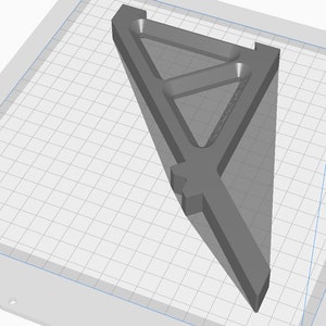 May include: A gray 3D printed triangular shelf bracket with a geometric design. The bracket is designed to be mounted to a wall.