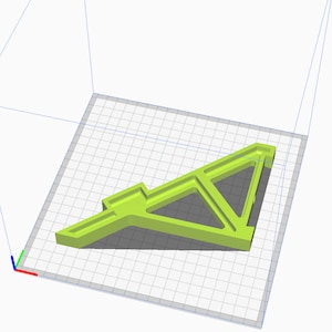 May include: A lime green 3D printed model of a geometric shape with a triangular base and multiple intersecting planes. The model is sitting on a gray grid surface.