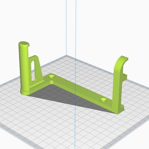 May include: A lime green, 3D-printed bracket with a triangular base and two vertical supports. Each support has a different design, one with a cylindrical top and the other with a curved hook. The base has two circular holes.