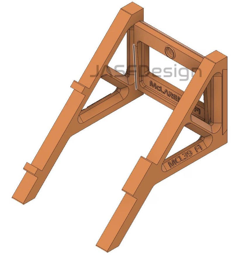 May include: A 3D-rendered, orange-colored support structure with angled legs and a rectangular frame. The text "JASE Design" and "McLaren" are visible. The model also has the text "MCL39 A".