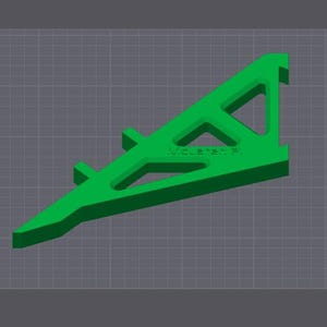 Puede incluir: Un objeto de pl&aacute;stico verde impreso en 3D con forma triangular y un patr&oacute;n de cuadr&iacute;cula. El objeto tiene un agujero en el centro y est&aacute; etiquetado como "VELVET.3D".