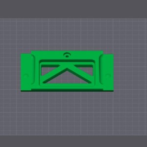 Puede incluir: Una pieza de pl&aacute;stico verde impresa en 3D con forma rectangular y un recorte en el centro. El recorte tiene forma triangular con un peque&ntilde;o agujero en la parte superior.