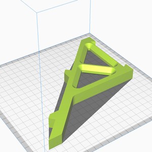 May include: A green plastic 3D printed model of a triangular stand with a hollow center. The stand is designed with a series of internal supports.