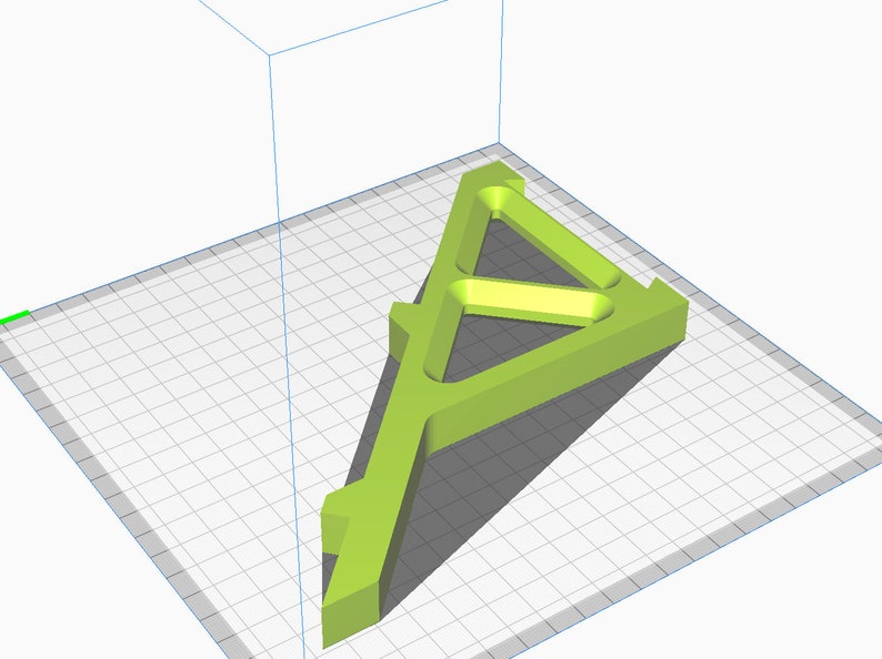 May include: A green plastic 3D printed model of a triangular stand with a hollow center. The stand is designed with a series of internal supports.