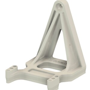 May include: A white plastic 3D printed model of a triangular stand with a rectangular base. The stand has a hole at the top and three holes on each side of the base.