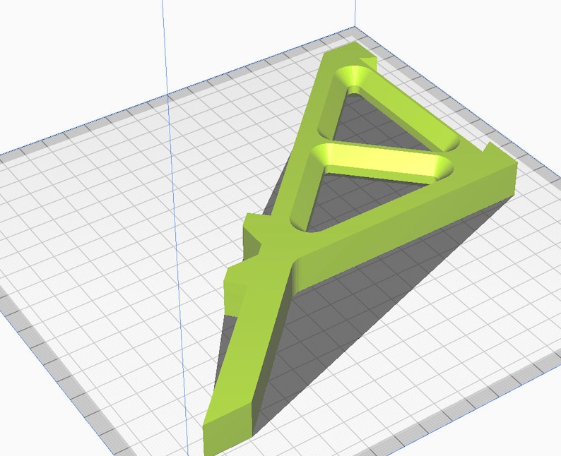 May include: A green plastic 3D printed object shaped like a triangle with a hollow center. The object is designed to be used as a stand or support.
