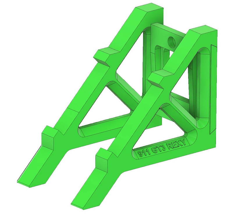 May include: A bright green, 3D-printed support structure. The design features angled supports and a central connecting piece. The text "911 GT3 REXY" is printed on the base. The structure is designed to hold an object.
