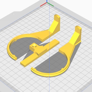 May include: A 3D-rendered image of three yellow plastic components. The components appear to be parts of a larger structure, with curved and rectangular shapes. The parts are arranged on a grid-like surface, suggesting a design or modeling environment.