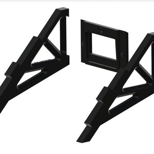 May include: Two black plastic triangular stands with a rectangular opening in the middle. The stands are designed to hold a phone or other device.
